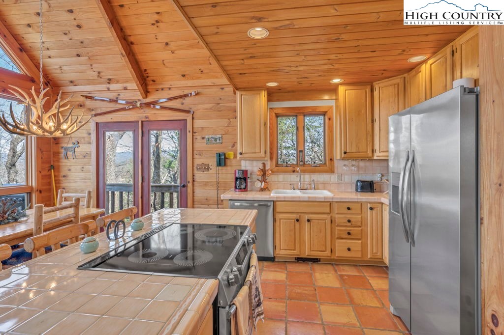 2095 Elk Ridge Road Ferguson, NC 28624 - Photo 24 of 34 a kitchen with stainless steel appliances granite countertop a sink stove and refrigerator