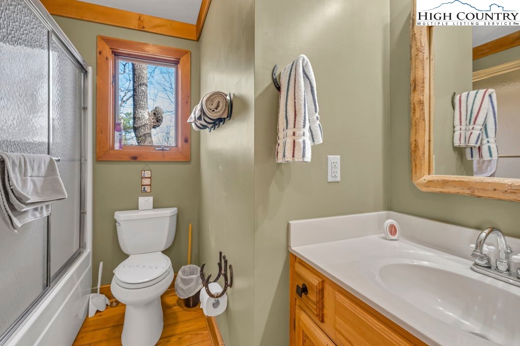 2095 Elk Ridge Road Ferguson, NC 28624 - Photo 26 of 34 a bathroom with a toilet sink and mirror