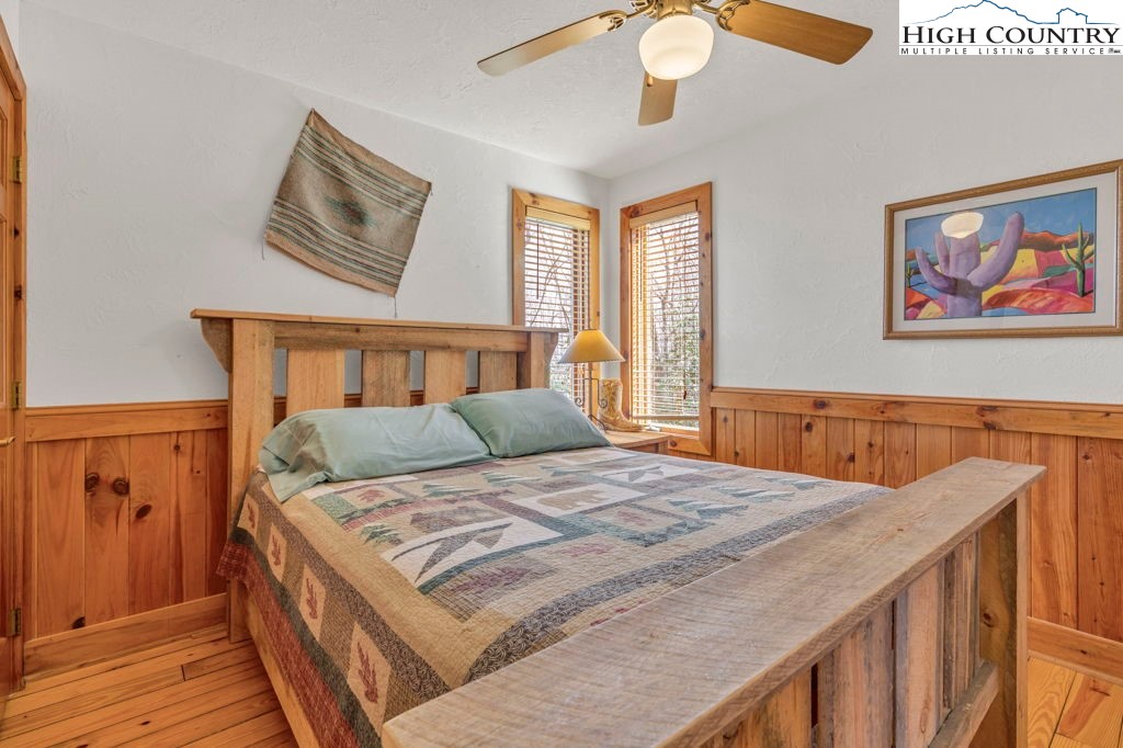 2095 Elk Ridge Road Ferguson, NC 28624 - Photo 27 of 34 a bedroom with a bed and a painting on the wall