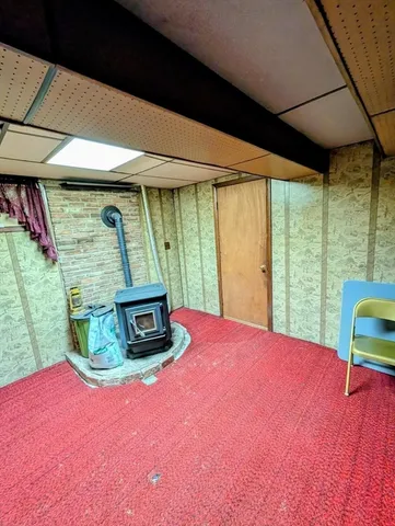 a bedroom with furniture and a large window