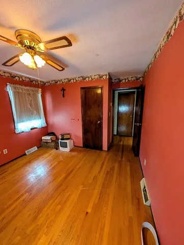a view of a room with wooden floor