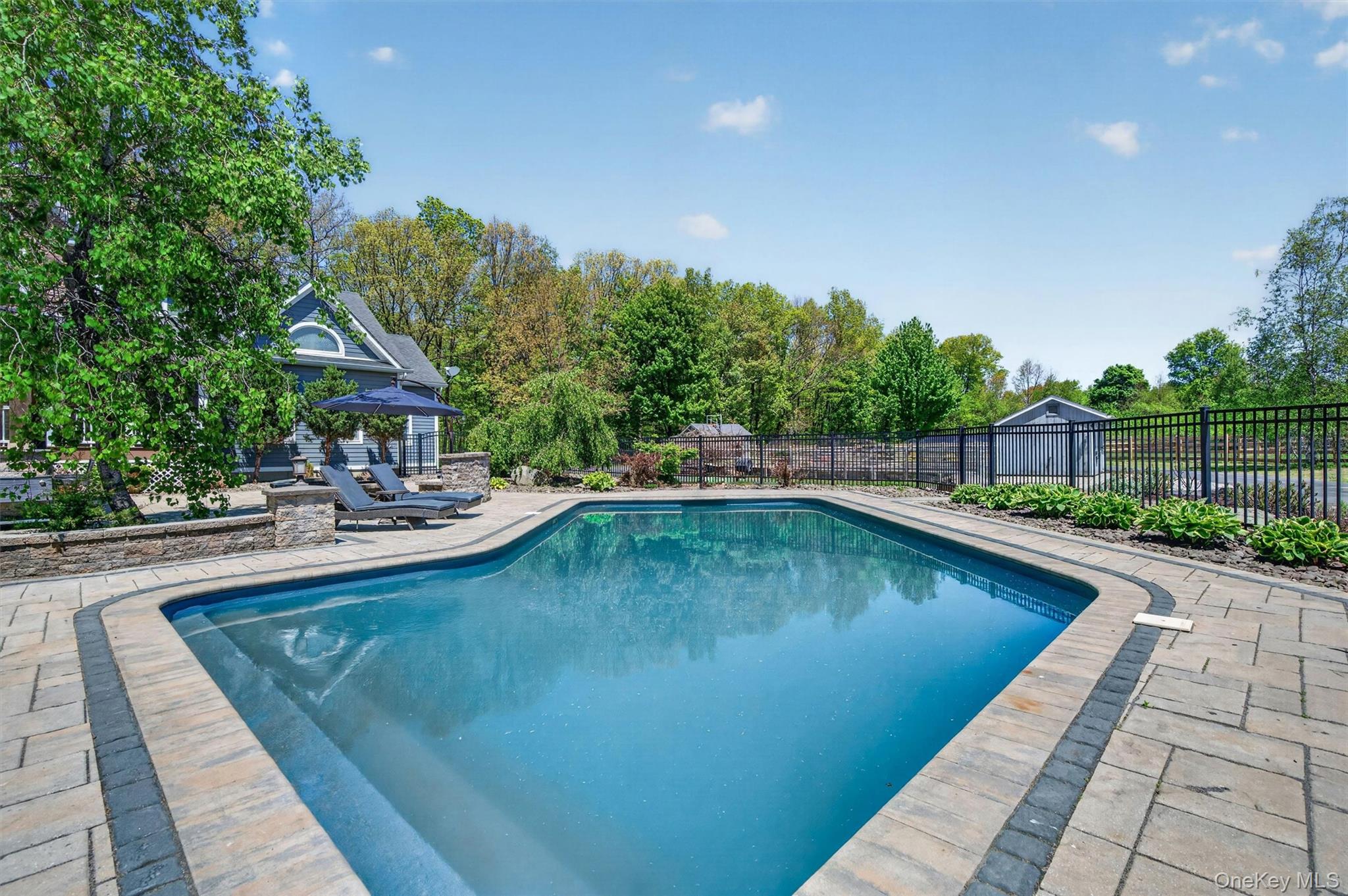 2 White Horse Road Middletown, NY 10940 - Photo 36 of 47 Dive into luxury with this heated saltwater pool, the perfect centerpiece for summer relaxation and poolside leisure.