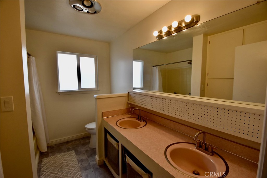 935 Truttman Lane Grenada, CA 96038 - Photo 16 of 44 a bathroom with a sink a vanity and mirror