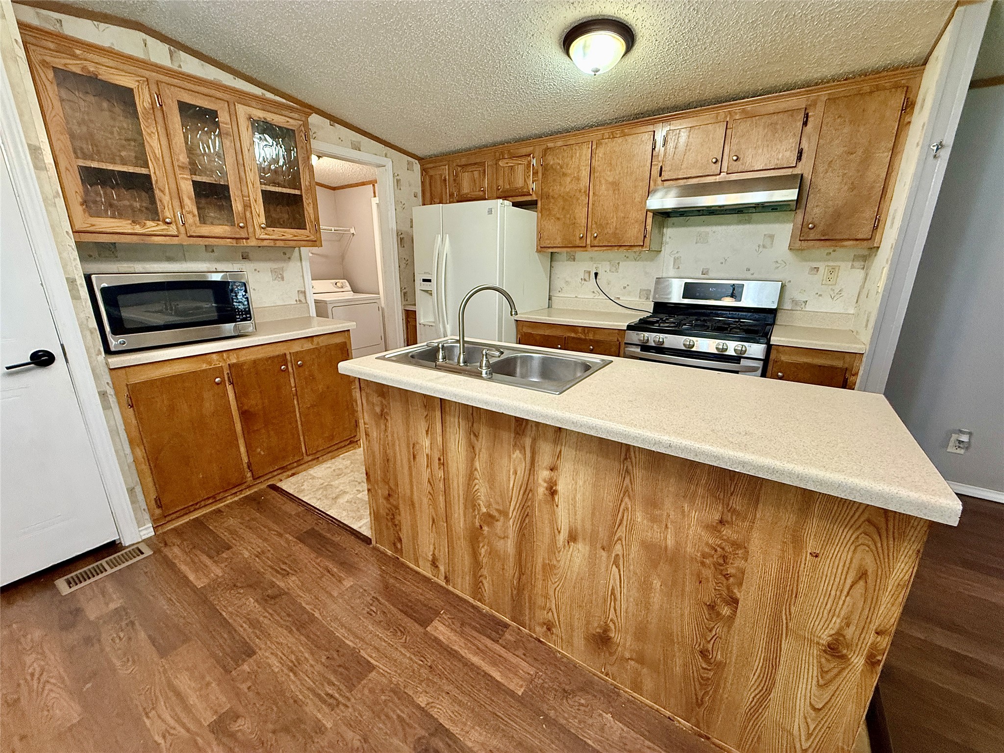 3075 FM 2001 Buda, TX 78610 - Photo 6 of 26 The kitchen offers ample counter space, full appliances, and access to the pantry.