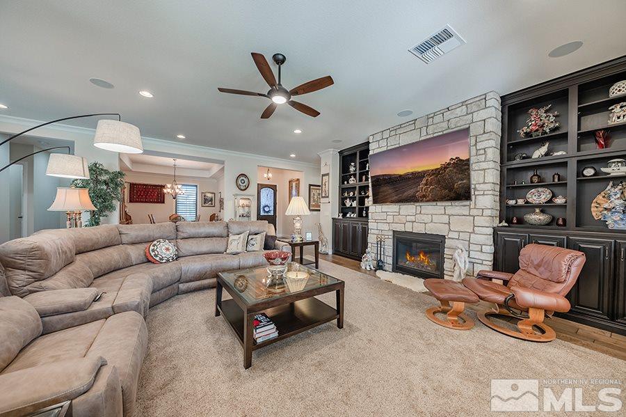 9850 Firefoot Lane Reno, NV 89521 - Photo 11 of 40 a living room with furniture a flat screen tv and a fireplace