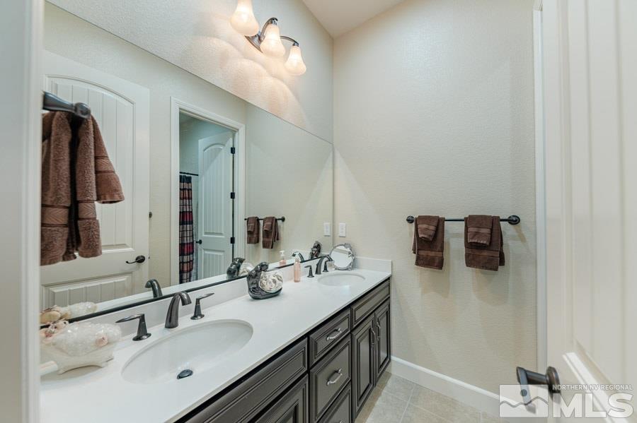 9850 Firefoot Lane Reno, NV 89521 - Photo 21 of 40 a bathroom with a double vanity sink and mirror