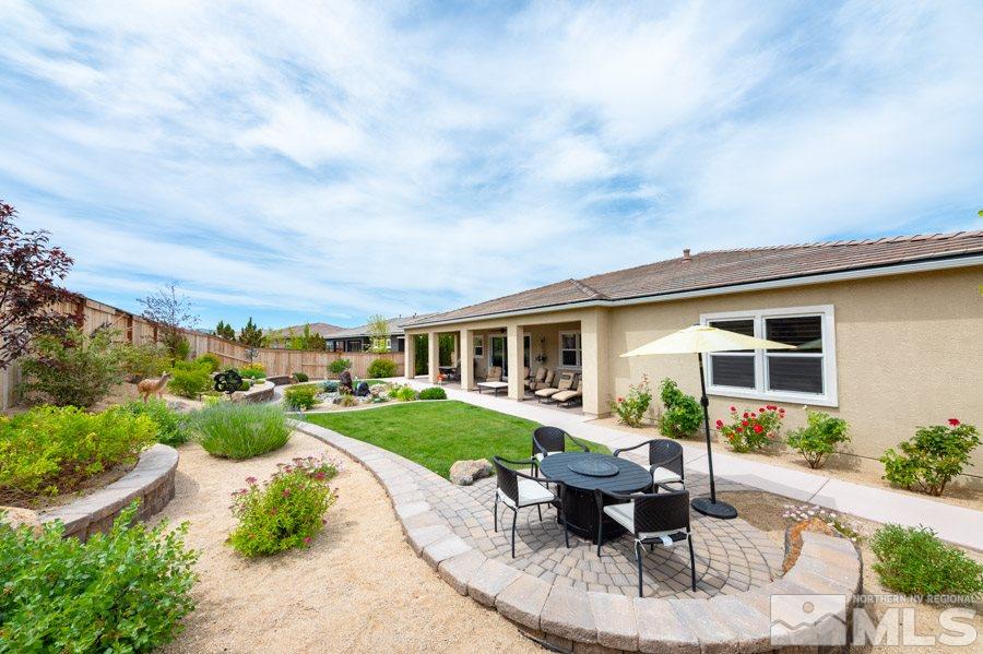 9850 Firefoot Lane Reno, NV 89521 - Photo 27 of 40 a view of a house with backyard sitting area and garden