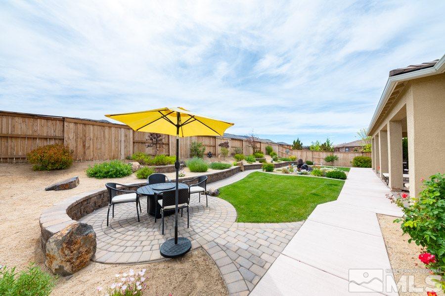 9850 Firefoot Lane Reno, NV 89521 - Photo 29 of 40 a view of a patio with a table and chairs under an umbrella