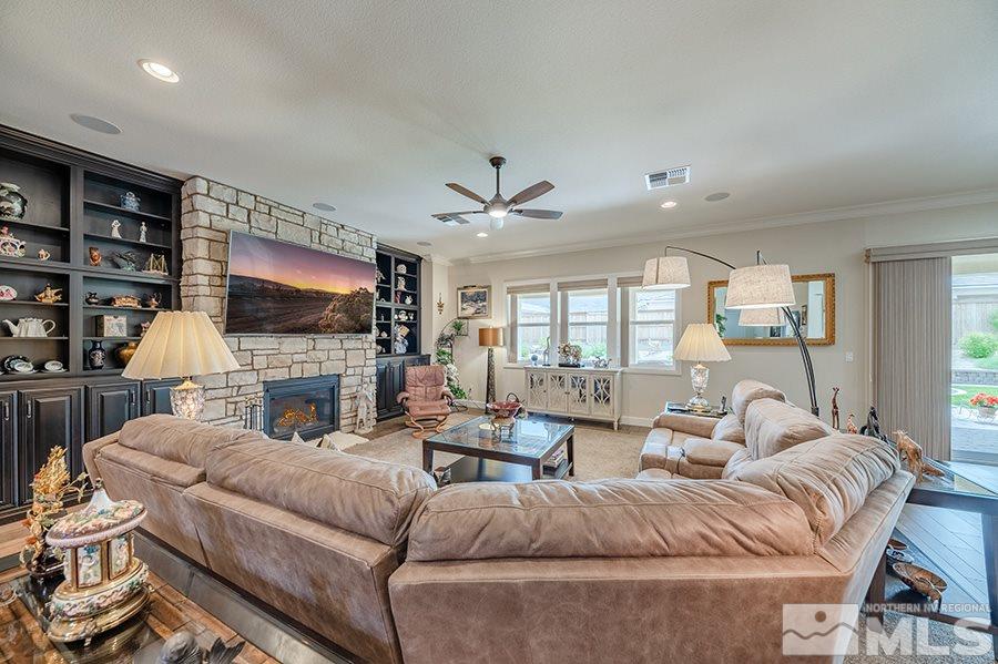 9850 Firefoot Lane Reno, NV 89521 - Photo 6 of 40 a living room with fireplace furniture and a flat screen tv