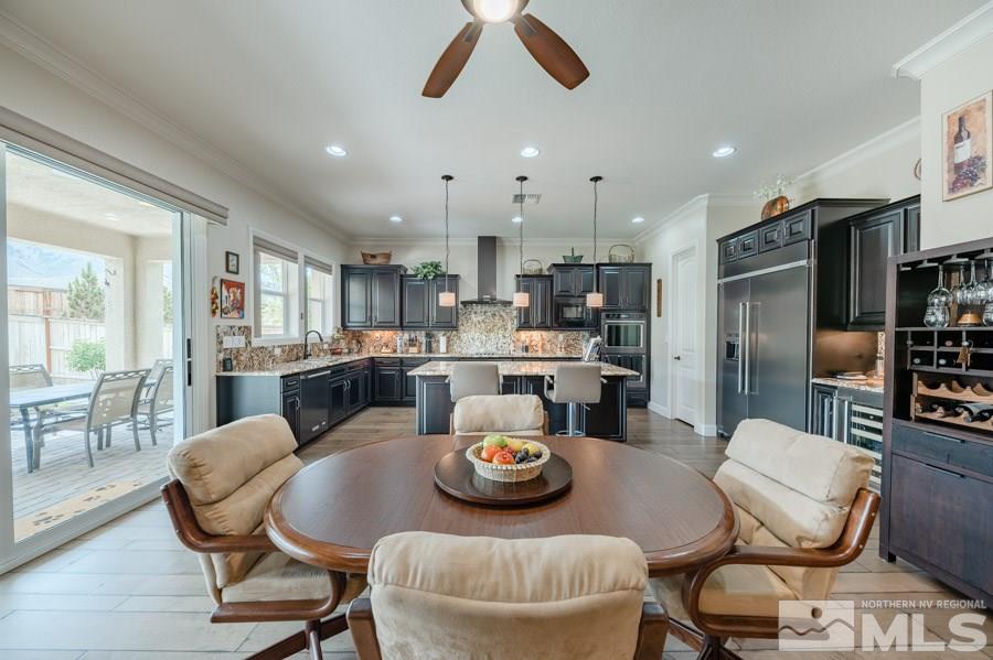 9850 Firefoot Lane Reno, NV 89521 - Photo 8 of 40 a kitchen with stainless steel appliances kitchen island granite countertop a dining table and chairs