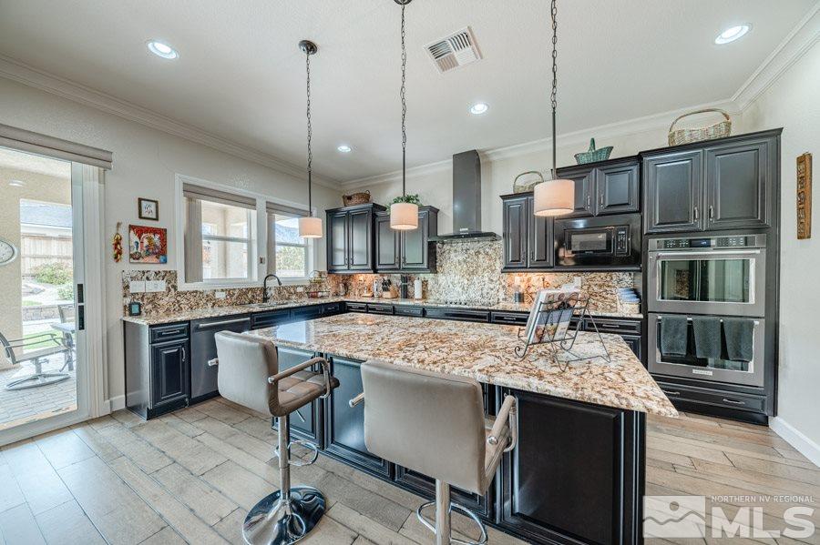 9850 Firefoot Lane Reno, NV 89521 - Photo 9 of 40 a kitchen with kitchen island a counter top space appliances and a center island