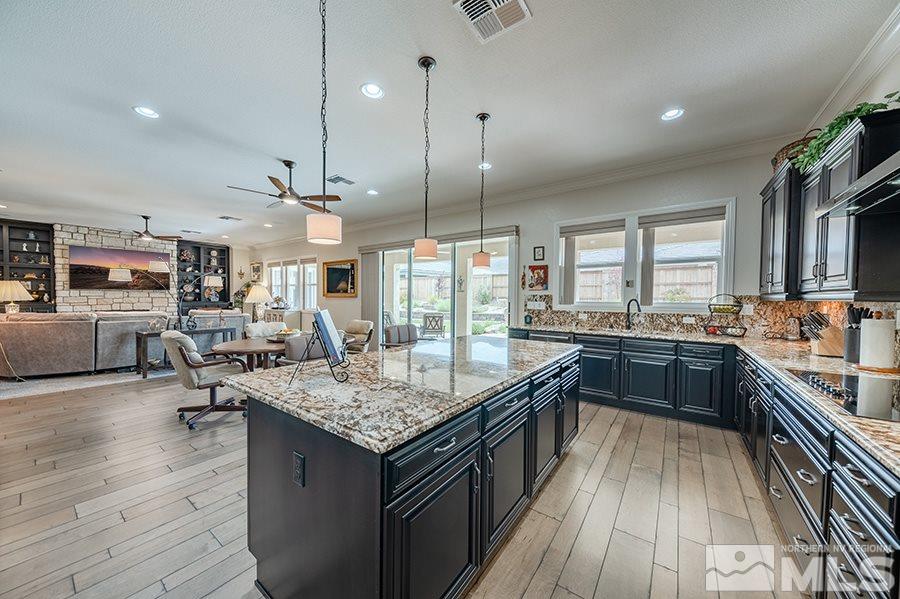 9850 Firefoot Lane Reno, NV 89521 - Photo 10 of 40 a kitchen with counter space appliances and wooden floor