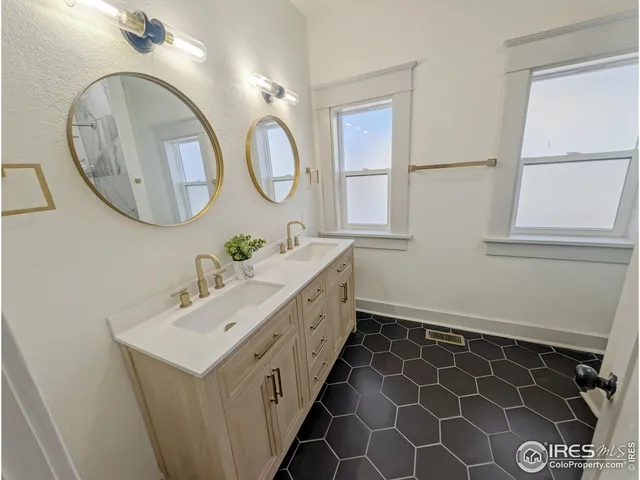 a view of a room with wooden floor and white walls