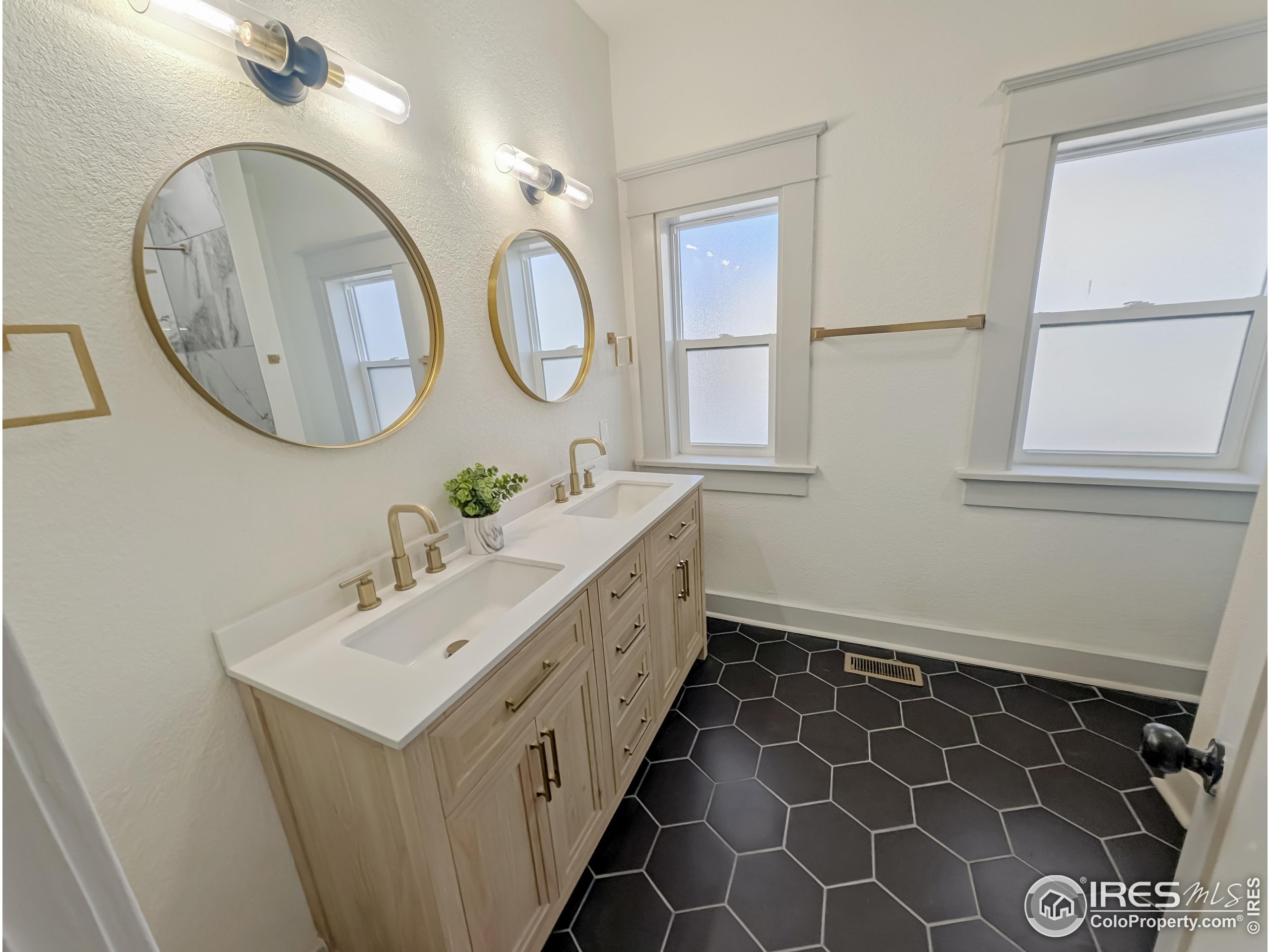 710 Carson Street Brush, CO 80723 - Photo 13 of 31 a bathroom with a double vanity sink mirror and