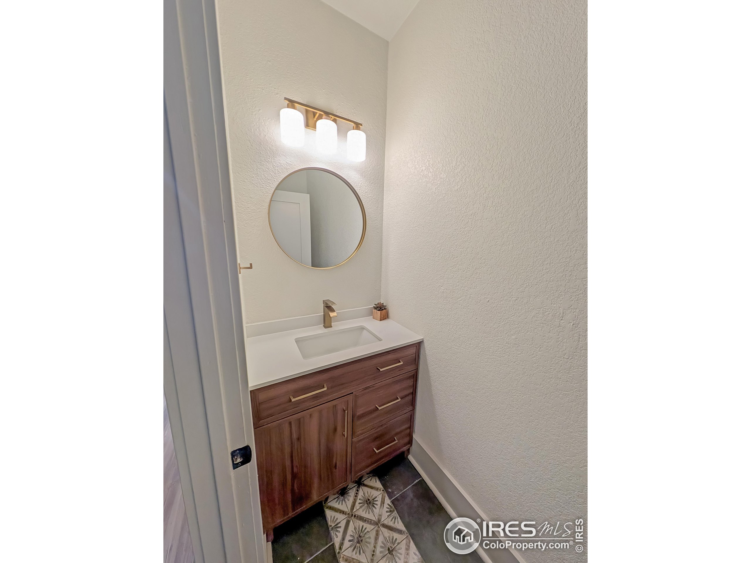 710 Carson Street Brush, CO 80723 - Photo 19 of 31 a bathroom with a sink and a mirror