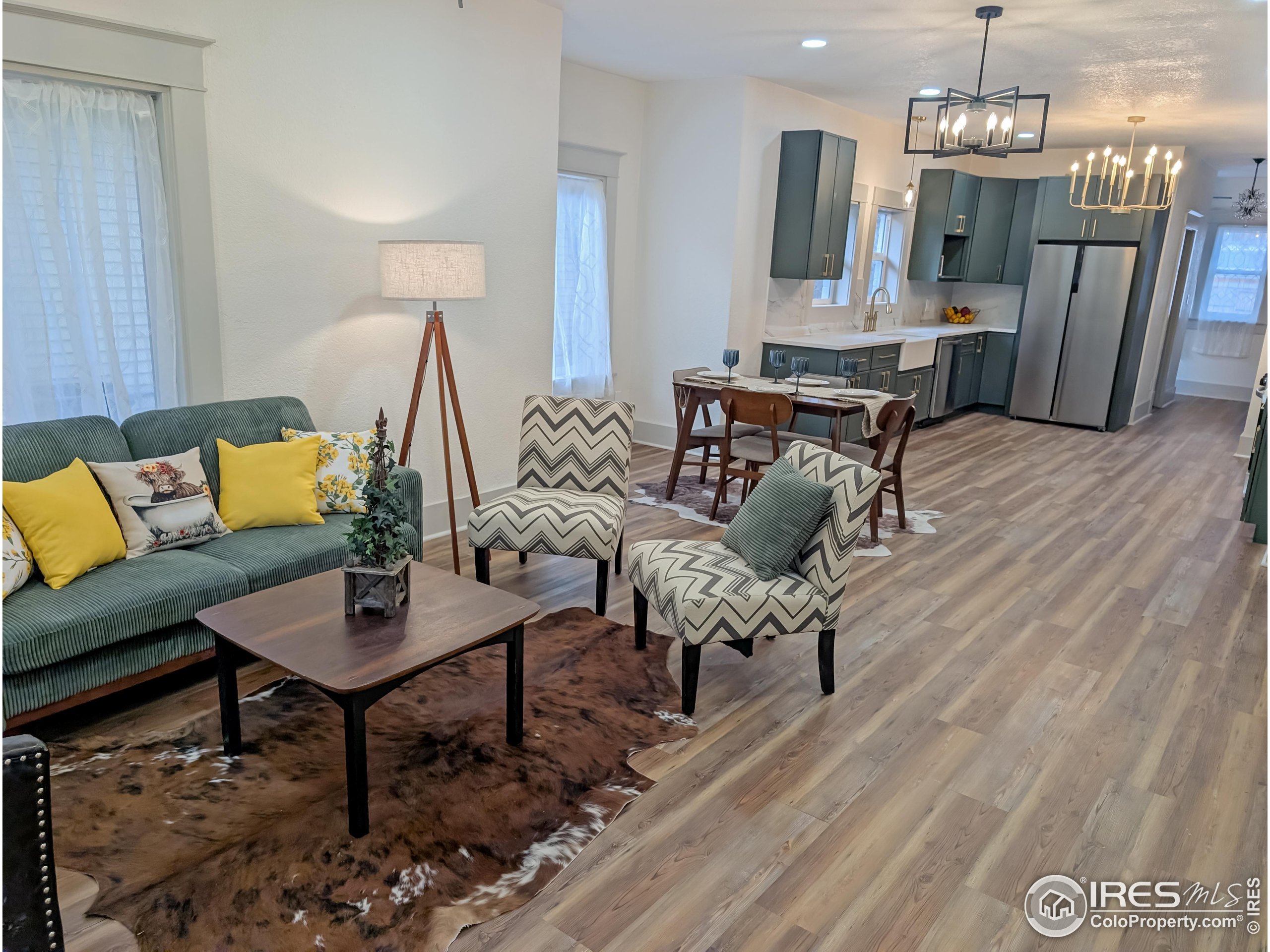 710 Carson Street Brush, CO 80723 - Photo 6 of 31 a living room with furniture and a chandelier