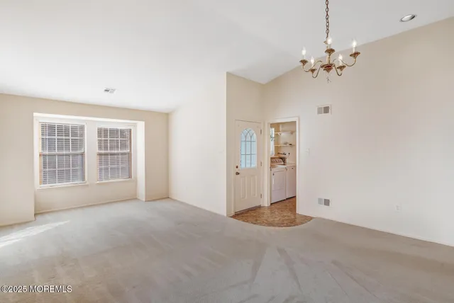a kitchen with cabinets stainless steel appliances and wooden floor