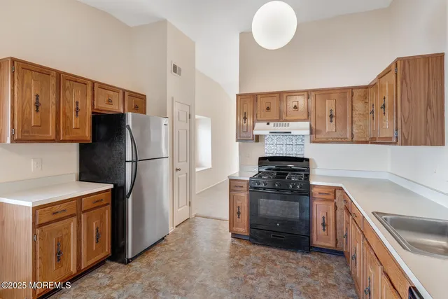 a kitchen with refrigerator and window