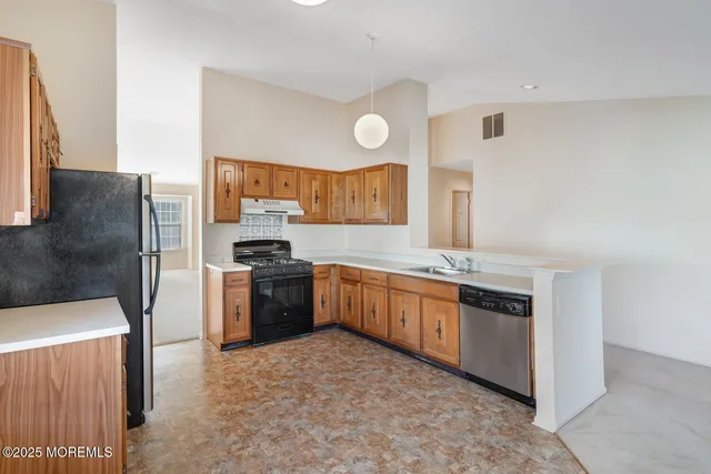 a view of a livingroom with furniture and a kitchen