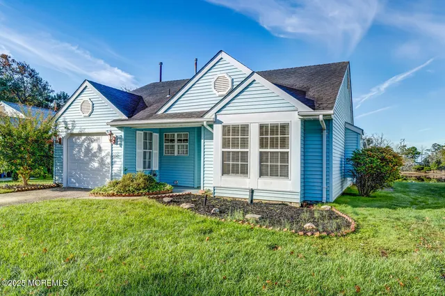 a front view of a house with a yard and outdoor seating