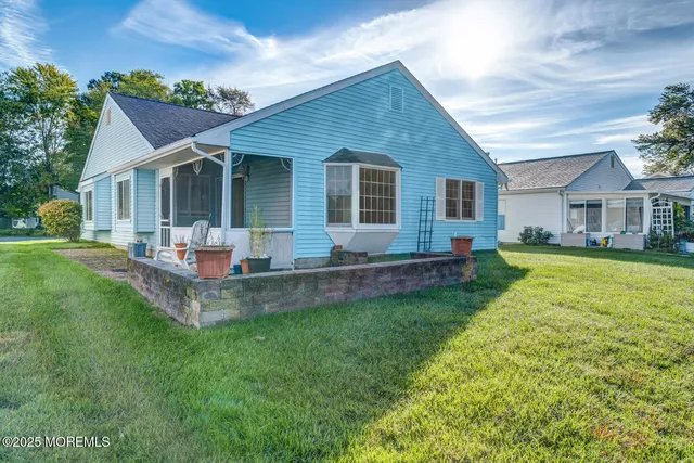a front view of house with yard and green space