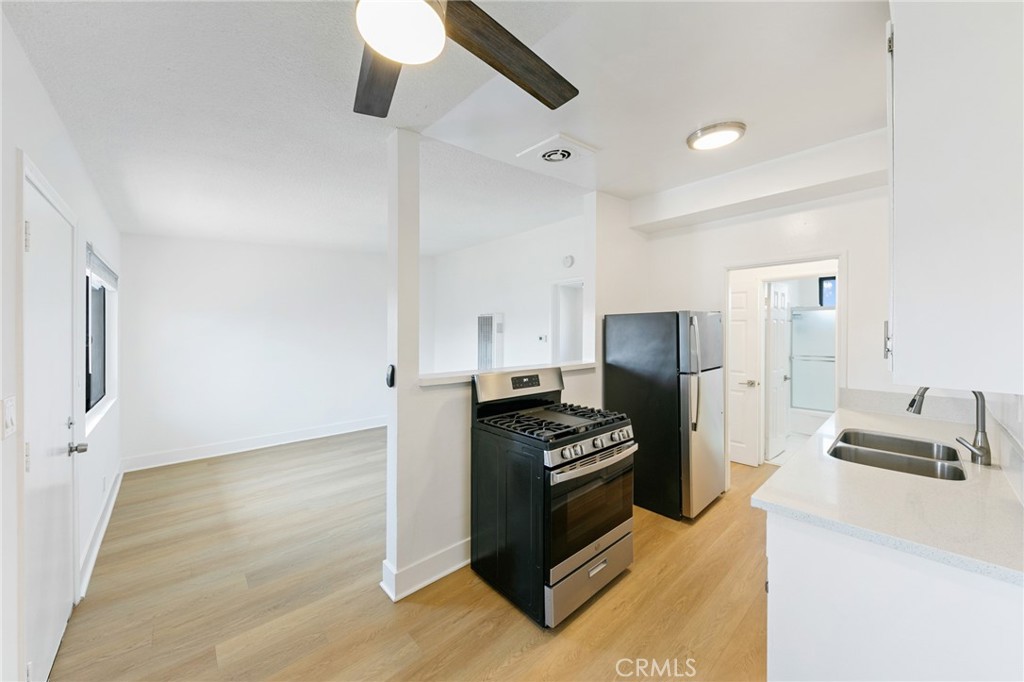 1242 Cedar Avenue Long Beach, CA 90813 - Photo 14 of 22 a kitchen with stainless steel appliances a refrigerator and a stove top oven