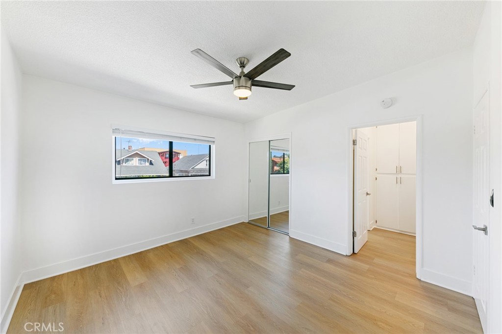 1242 Cedar Avenue Long Beach, CA 90813 - Photo 16 of 22 an empty room with wooden floor and ceiling fan