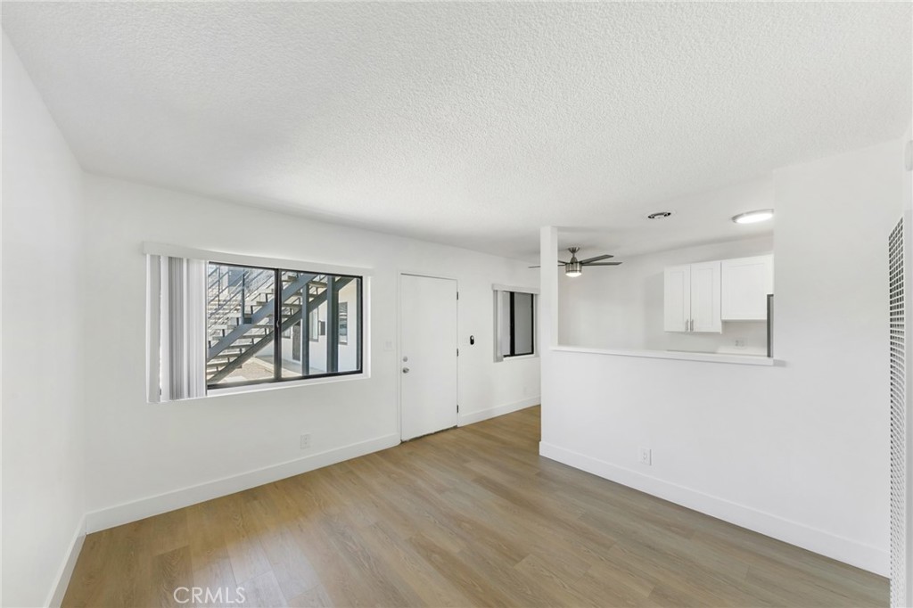 1242 Cedar Avenue Long Beach, CA 90813 - Photo 7 of 22 a view of an empty room with wooden floor and a window