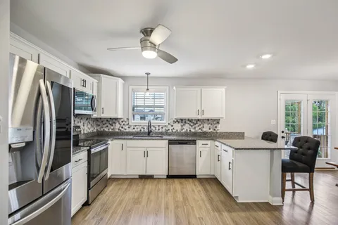 a kitchen with stainless steel appliances a sink stove and refrigerator