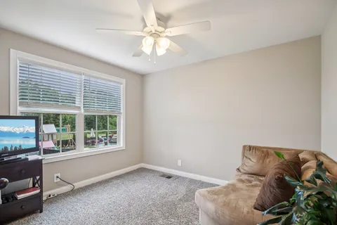 a bed sitting in a bedroom next to a window