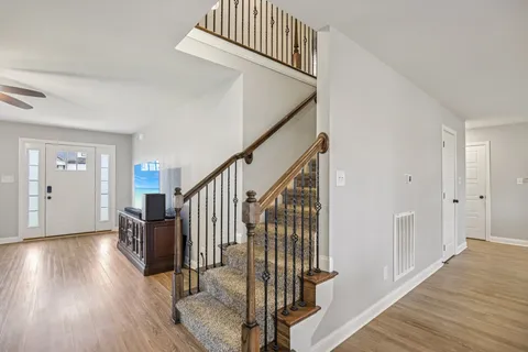 a view of entryway with wooden floor and stairs