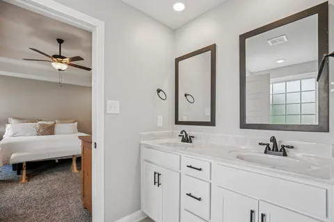 a bathroom with double sink and a mirror