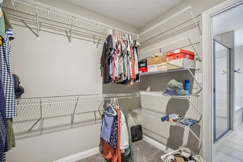 a bedroom with bed couch and window