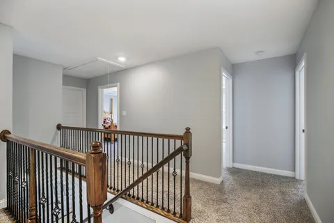 a bathroom with a toilet a sink a mirror and vanity