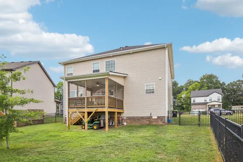 a view of a house with a backyard