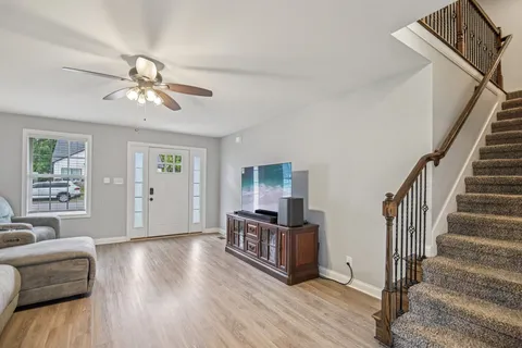 a living room with furniture and wooden floor
