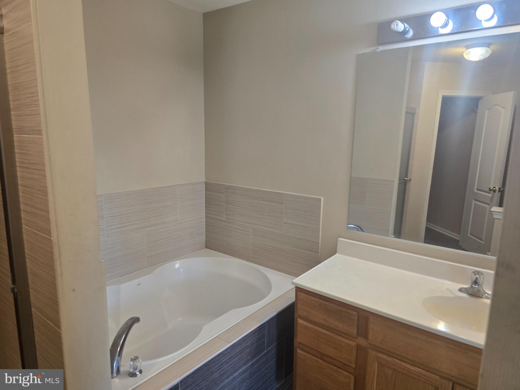 102 Royal Bonnet Place Frederick, MD 21702 - Photo 22 of 23 a bathroom with a sink and a large mirror