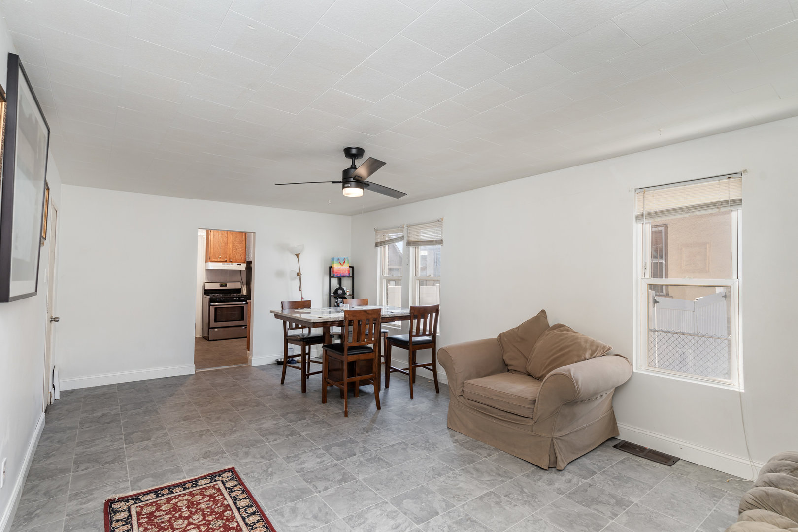 1311 Kane Street Aurora, IL 60505 - Photo 3 of 13 a living room with furniture a dining table and a window
