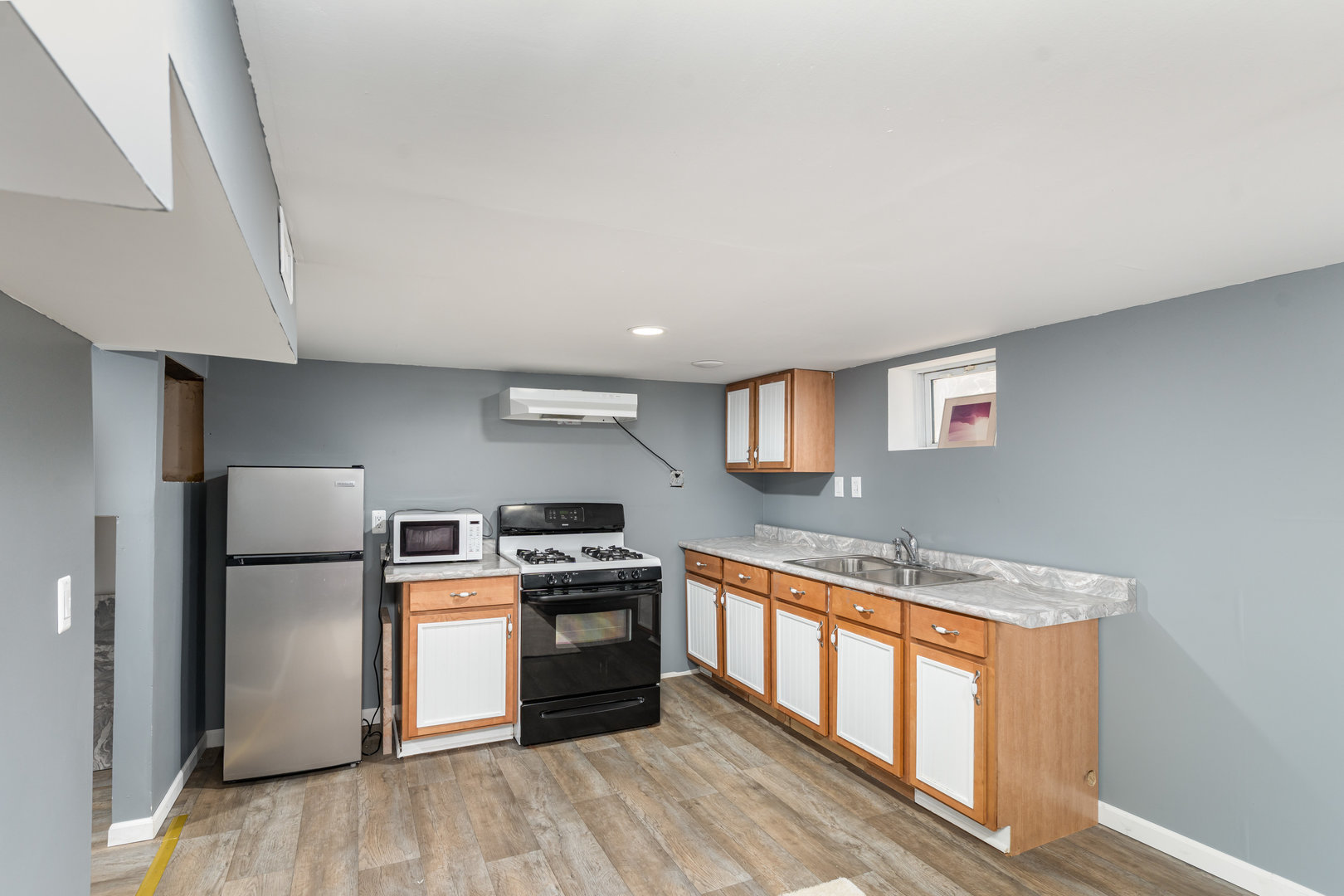 1311 Kane Street Aurora, IL 60505 - Photo 9 of 13 a kitchen with stainless steel appliances granite countertop a stove a sink and a refrigerator