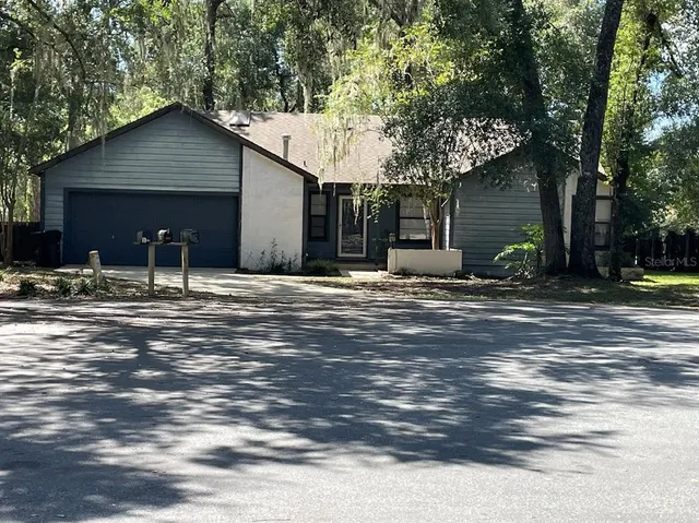 a backyard of a house with yard and outdoor seating