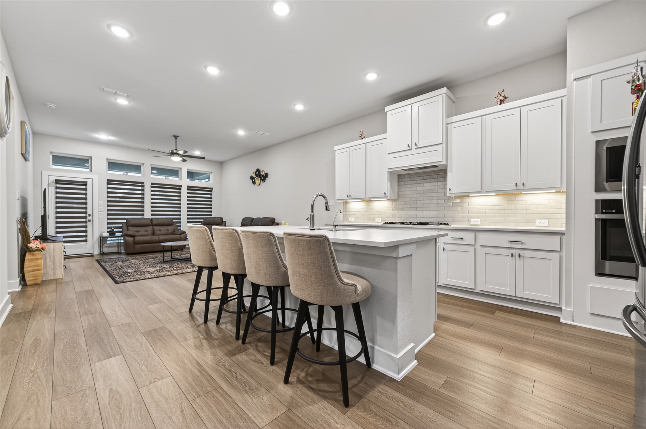 147 Nightshade Street Richmond, TX 77406 - Photo 12 of 47 A beautiful, modern kitchen designed for gathering. Features include sleek quartz countertops and a large central island, providing the perfect hub for family events and daily life.