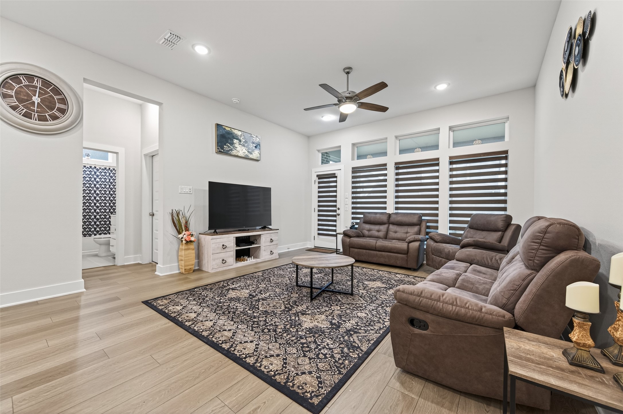 147 Nightshade Street Richmond, TX 77406 - Photo 10 of 47 Bright and airy open living space defined by floor-to-ceiling windows, offering abundant sunshine and a serene atmosphere perfect for modern living