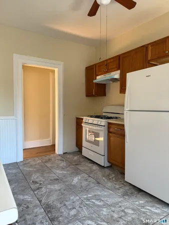 a kitchen with a refrigerator and a stove top oven