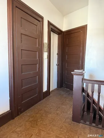 a workspace room with furniture and wooden closet