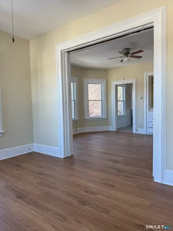a view of a big room with wooden floor and a fireplace