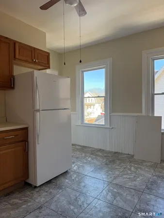 a white refrigerator freezer and a stove sitting in a kitchen