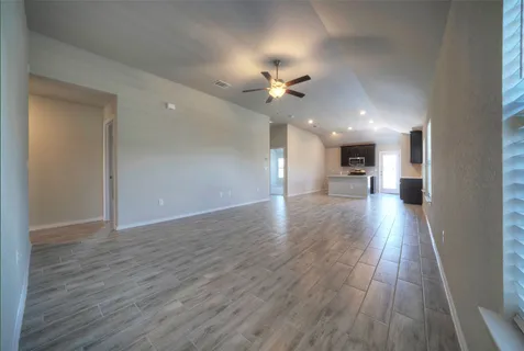 a view of a hallway with wooden floor