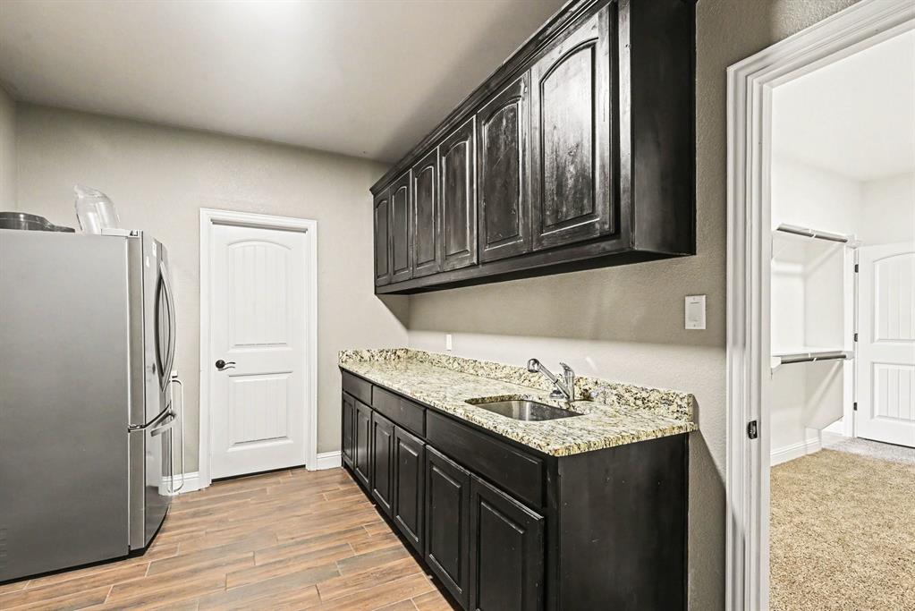 104 Stanford Lane Springtown, TX 76082 - Photo 9 of 28 a kitchen with a stove and a refrigerator