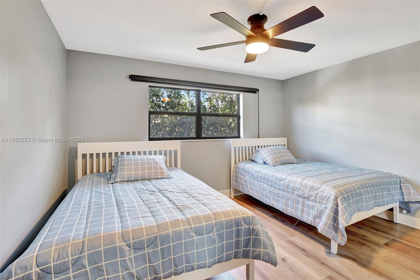 520 Orton Avenue, Unit 303 Fort Lauderdale, FL 33304 - Photo 12 of 20 a bedroom with a bed and a large window