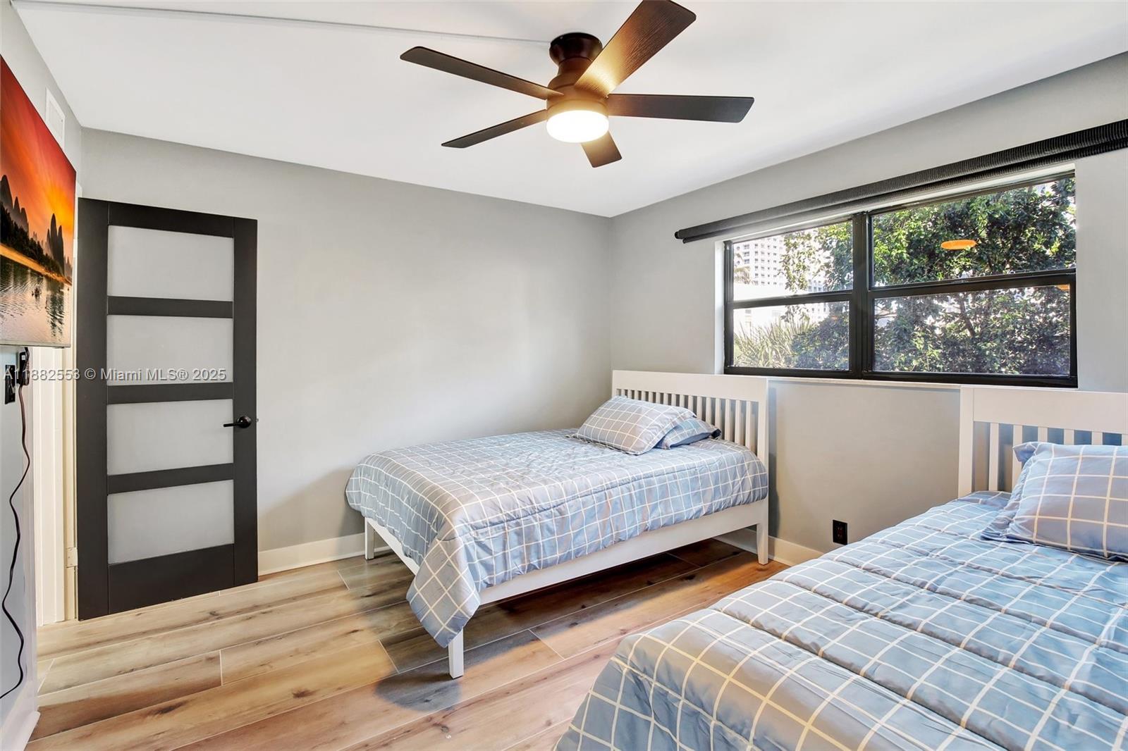 520 Orton Avenue, Unit 303 Fort Lauderdale, FL 33304 - Photo 13 of 20 a bedroom with two beds and a window